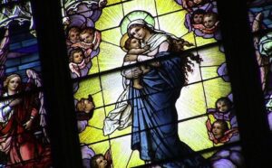 A stained glass window depicting the virgin and child.