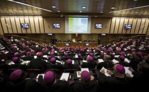 A large group of people in purple robes sitting in a room.