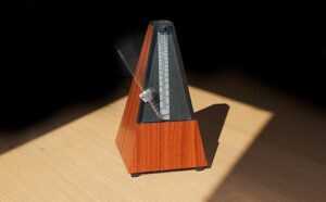 A wooden instrument is sitting on a table with a light shining on it.