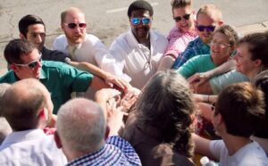 A group of people holding hands in a circle.