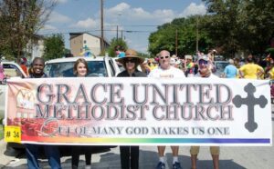 A group of people holding a sign.