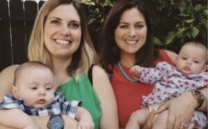 A group of women holding a baby.