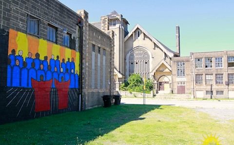 A mural painted on the side of an old building.