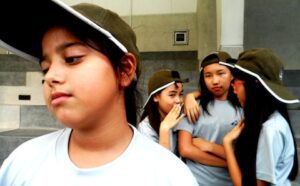 A group of young girls wearing hats.