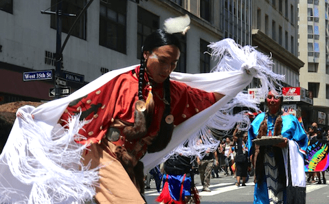 A man wearing a feathered headdress.