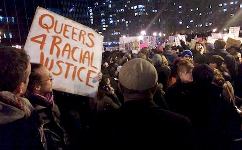 A group of people holding a sign that says queers for racial justice.