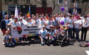 A group of people posing for a photo at the pride parade.