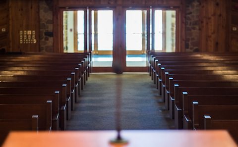 Empty wooden pews in a church.