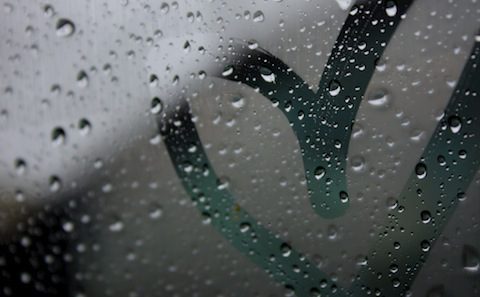 A close up of a raindrop on a car window.