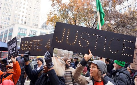 A group of people holding signs that say justice.