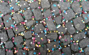 Colorful confetti on a cobblestone street.