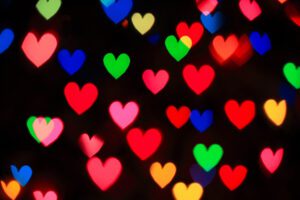 A blurred image of many colorful hearts.