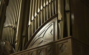 A close up of a pipe organ in a church.