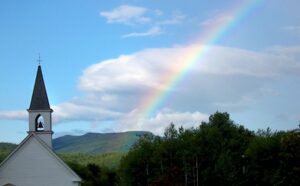 A rainbow over a house.