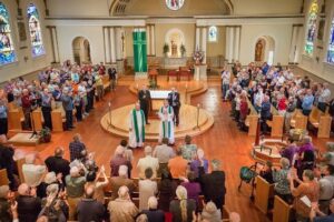 A large group of people standing in a church.