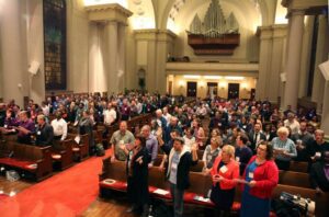 A large group of people standing in a church.