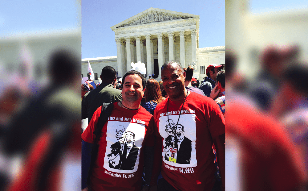 Two men in red t - shirts standing in front of the supreme court.