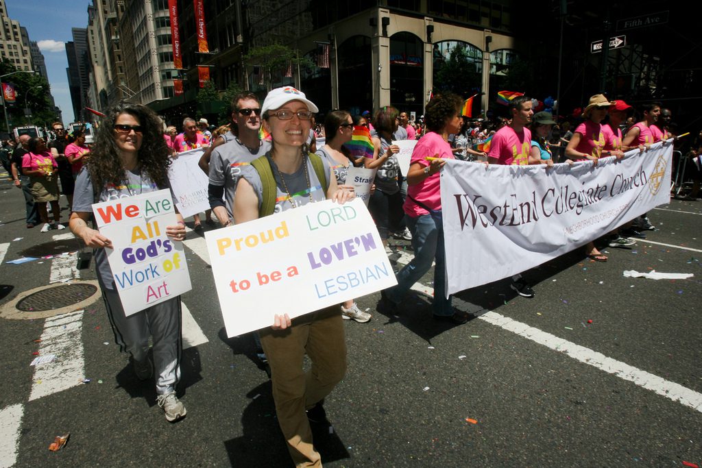 A group of people holding signs in a parade.