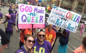 A group of people holding signs that say god made me gay.
