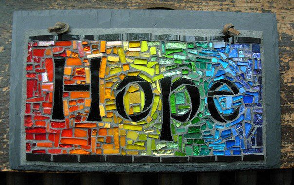 A stained glass sign with the word hope on it.