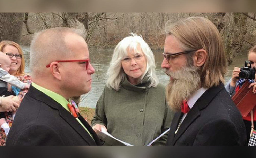 A man with a beard and a woman with a bow tie.