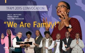 A group of people standing in front of a poster with the words we are family.