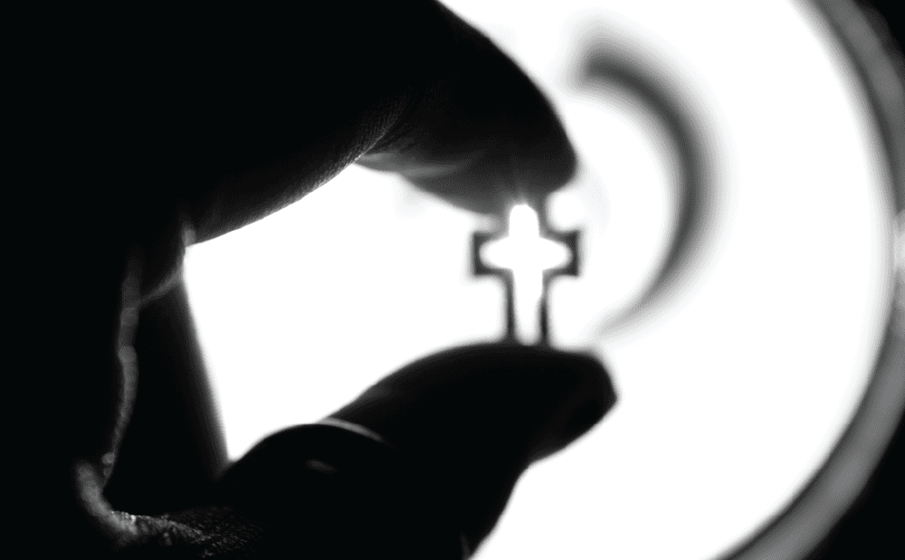 A black and white photo of a hand holding a key.