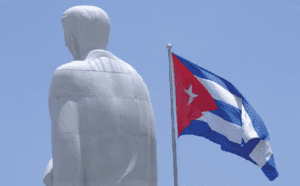 A statue with a cuba flag in front of it.