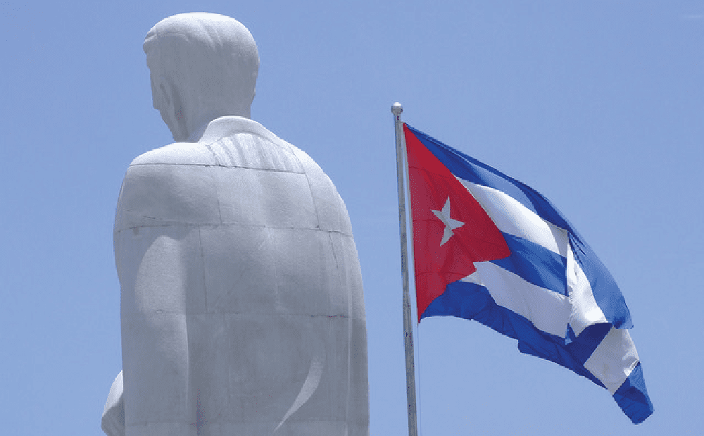 A statue with a cuba flag in front of it.