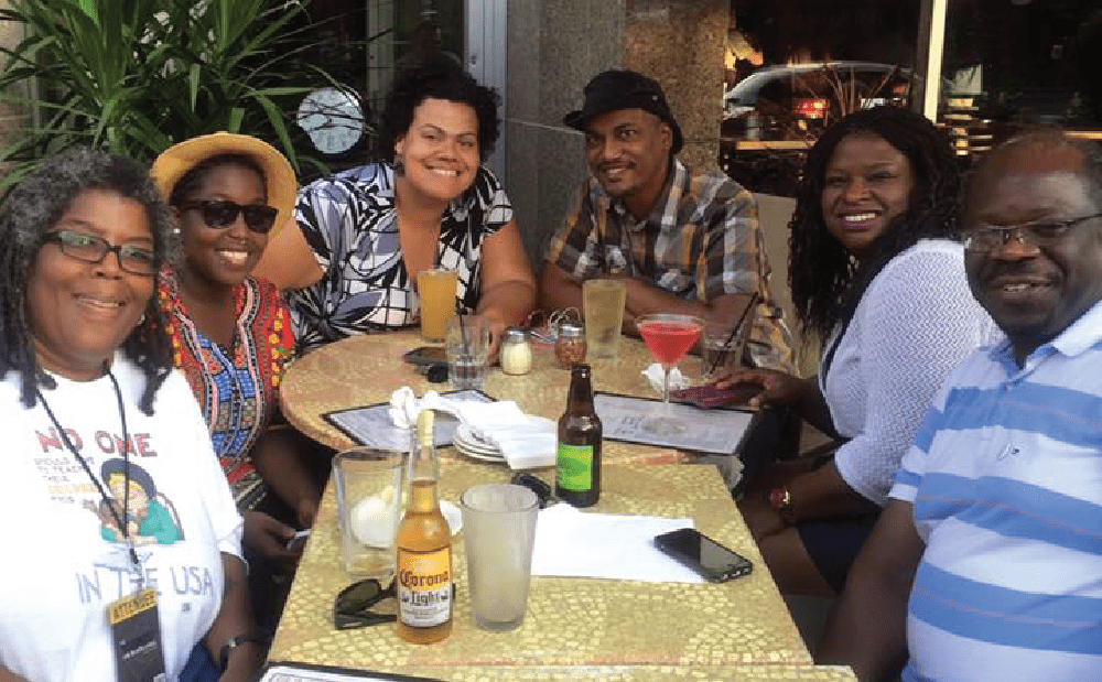 A group of people sitting at a table with drinks.