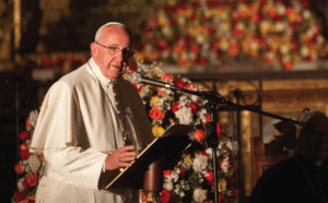 Pope francis gives a speech in front of a large group of people.