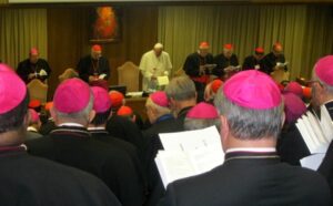 A group of priests wearing pink hats.