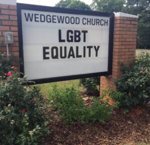 A sign that says wedgwood church lgbt equality.