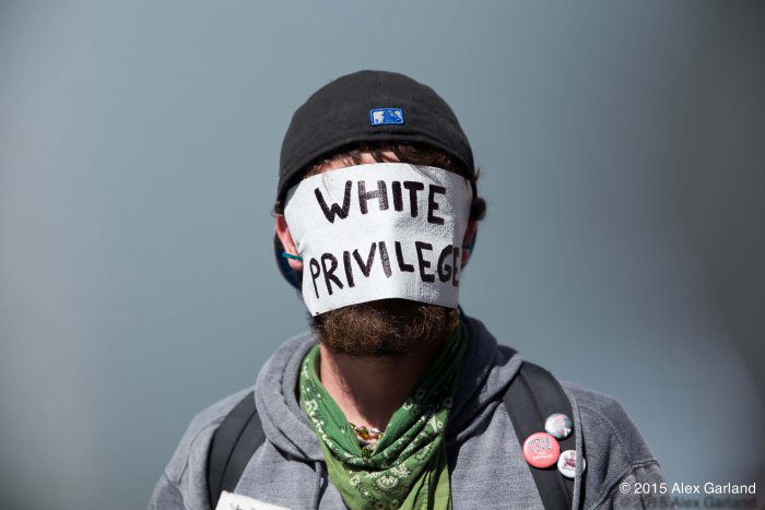 A man with a white band over his face.