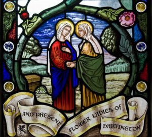 A stained glass window depicting jesus and mary.