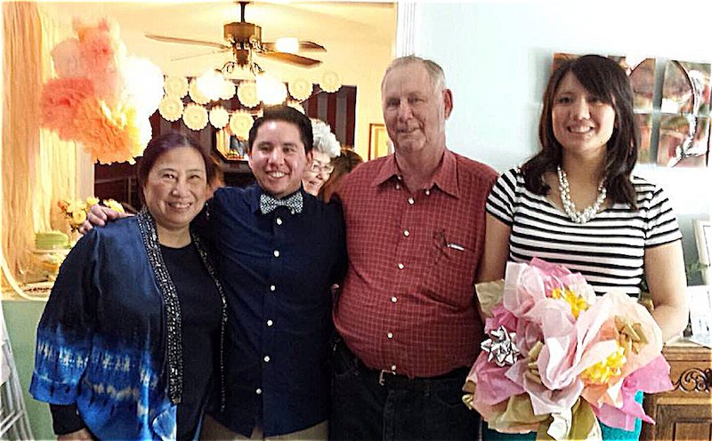 A group of people posing for a picture in a living room.