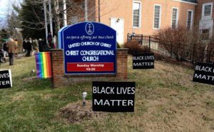 Black lives matter signs in front of a church.