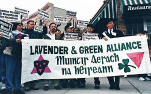 A group of people holding a banner that says lavender and green alliance.