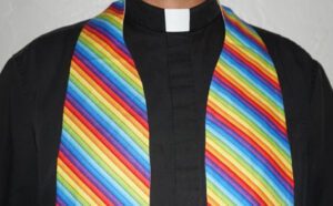 A man wearing a rainbow striped scarf.