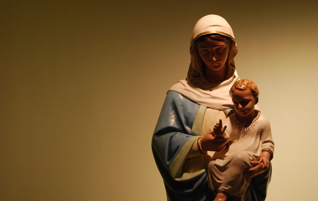 A statue of mary holding a child.