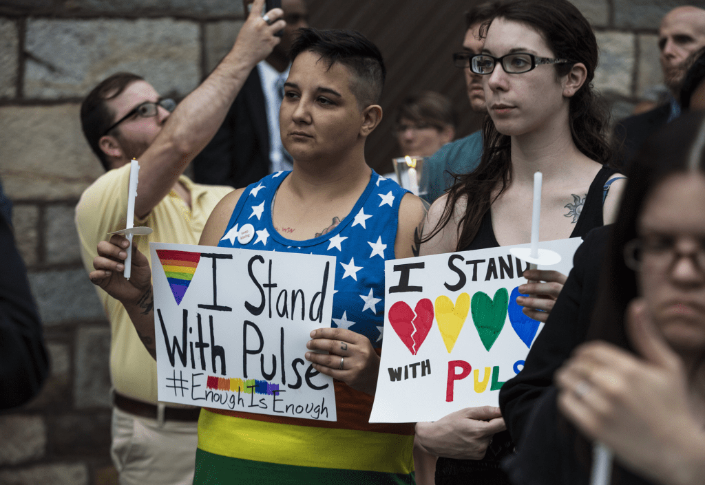 A group of people holding signs in front of a building.