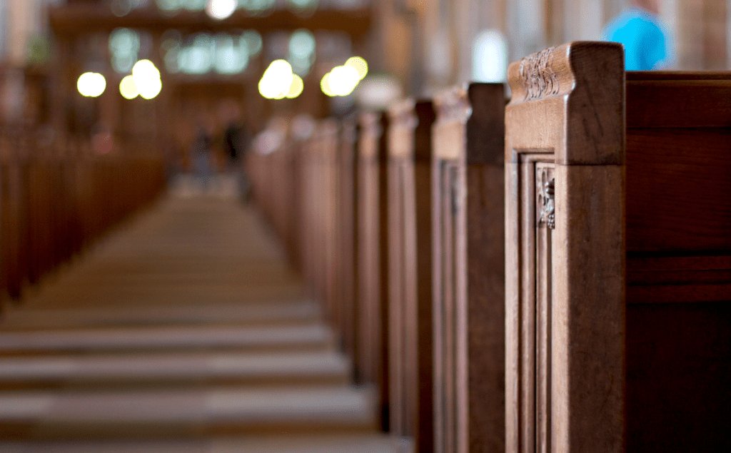 A row of wooden pews in a church.