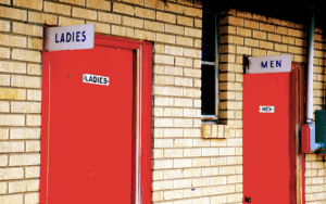 Two red doors on a brick wall.