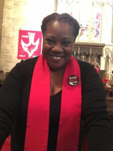 A woman wearing a red scarf in a church.