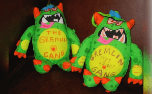 Two stuffed monsters that say the gremlin gang.