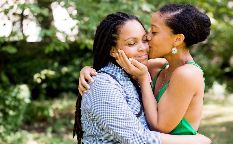 Two women hugging each other in a park.