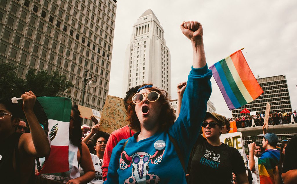 A group of people holding up flags in a city.