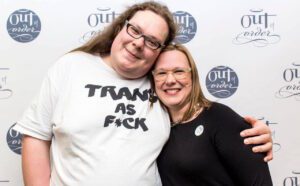 Two women posing for a photo at a trans as pick event.