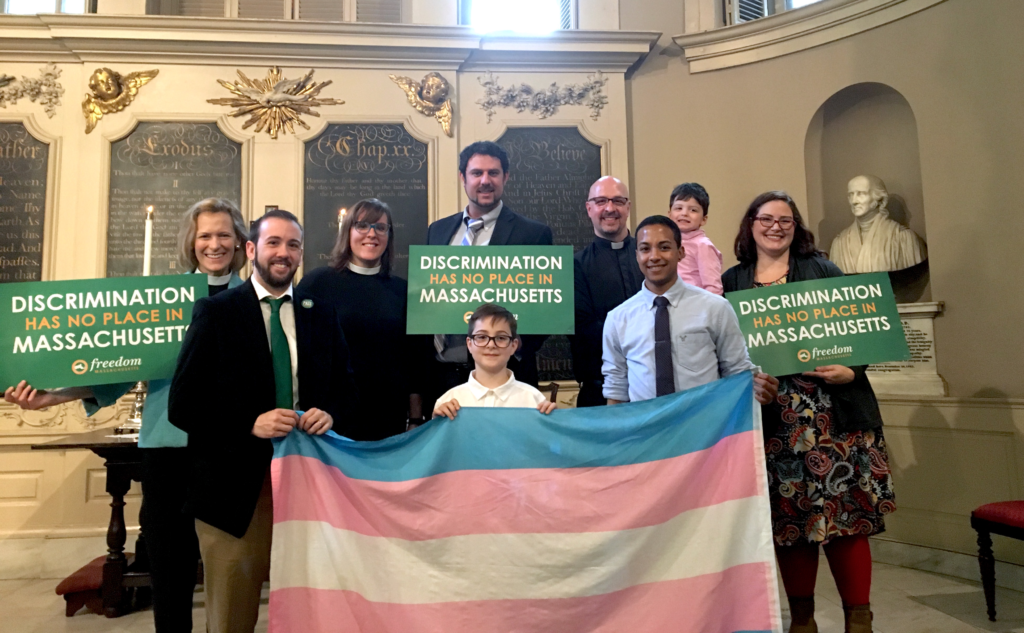 A Boy Holding A Transgender Flag With Boards