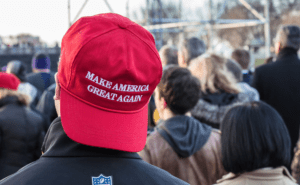 A man wearing a red hat with the words make america great again.